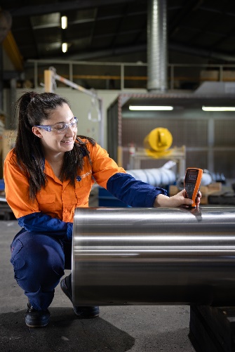 a girl is checking a hydraulic cylinder